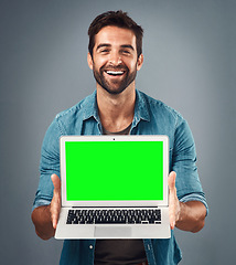 Image showing Happy man, laptop and portrait with mockup green screen for advertising or marketing against grey studio background. Male person showing computer display, chromakey or mock up space for advertisement