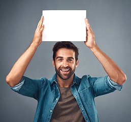 Image showing Happy man, portrait and poster on mockup for advertising, marketing or branding against a grey studio background. Male person holding rectangle billboard or placard for sign, message or advertisement