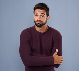 Image showing Unsure, confused and portrait of man in studio with confused, uncertain and thoughtful on blue background. Thinking, mockup space and face of male person skeptical for decision, choice and question