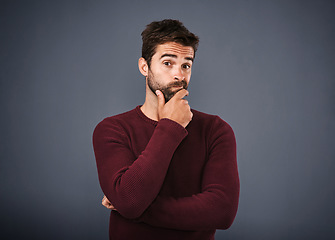 Image showing Doubt, thinking and portrait of man with unsure, uncertain and thoughtful on gray background. Wondering, mockup space and face of male person confused for decision, choice and question in studio