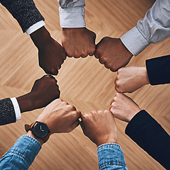 Image showing Team building, fist bump or hands of business people for motivation, group support or community in office. Teamwork, above or circle of fists for diversity, collaboration or partnership for a mission