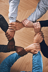 Image showing Collaboration, holding or hands of business people with diversity for office support or teamwork. Zoom, link or above of group of employees with mission or team building for startup goals together