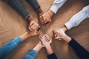 Image showing Above, motivation or business people holding hands for support, team building or teamwork in office. Partnership, zoom or employees in group collaboration with diversity or mission for goals together