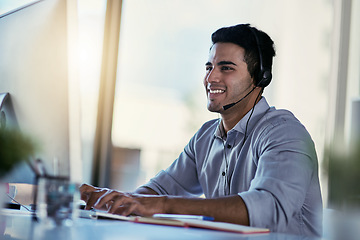 Image showing Customer support agent, smile and man in office consulting with advice, crm and happiness at work. Happy phone call, conversation and telecom help desk consultant speaking into headset at computer.