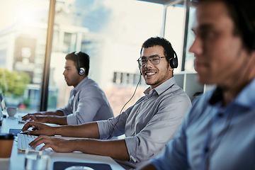 Image showing Customer service, smile and coworking, portrait of happy man consulting with advice, computer and team at help desk. Phone call, conversation and happiness, callcenter consultant in modern office.