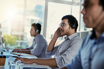 Image showing Customer service, coworking and man consulting with phone call, advice and sales info in modern office. Help desk, conversation and crm team, callcenter consultant speaking and listening at computer.