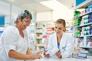 Image showing Pharmacist explaining prescription medication to woman in the pharmacy for pharmaceutical healthcare treatment. Medical, counter and female chemist talking to patient on medicine in clinic dispensary
