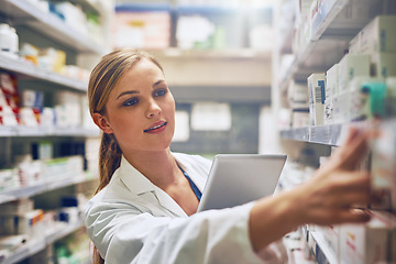 Image showing Medicine, woman pharmacist with tablet and looking for prescription in an isle at the pharmacy or clinic. Healthcare, pharmaceutical and female person search for medication with digital device