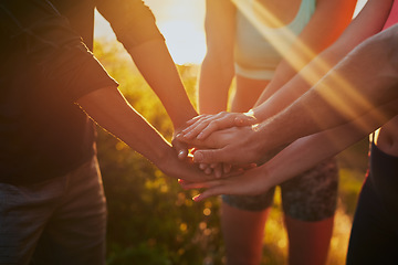 Image showing Hands together, fitness group and outdoor with motivation, workout and teamwork in nature. Exercise, sport and people with hand in sign for support, training and goal with solidarity and sun