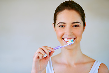 Image showing Woman, toothbrush and toothpaste brushing teeth in bathroom for health, happiness and wellness in morning. Girl, portrait or cleaning mouth for healthcare, dental care and oral hygiene in home mockup