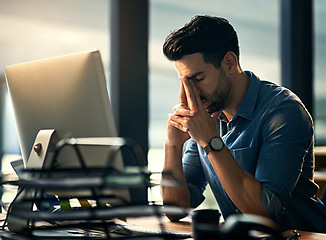 Image showing Stress, headache and tired with a business man in his office, sitting eyes closed at his desk for a deadline. Night, burnout and exhausted with a young male employee struggling with pain at work