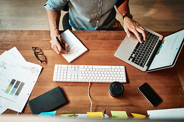 Image showing Top view, laptop and business man writing notes for planning, strategy and online data analysis at office desk. Worker, computer and notebook for trading, research and productivity in startup agency