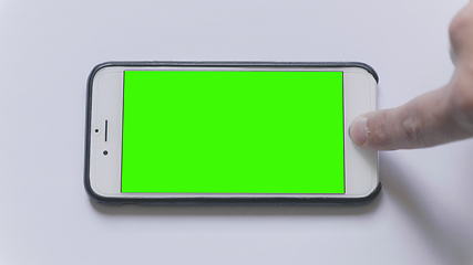 Image showing MOSCOW - JUNE 3, 2017: firmware updatethe Apple iPhone on a white background green screen in Russia on June 3, 2017 in Moscow, Russia.