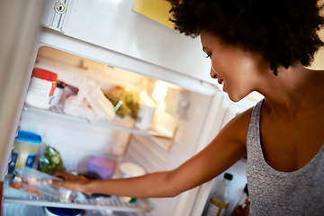 Image showing Woman, search fridge and food with smile, hungry and thinking for diet, meal and choice in home kitchen. Young african girl, happy and decision for breakfast, lunch or dinner in house for nutrition