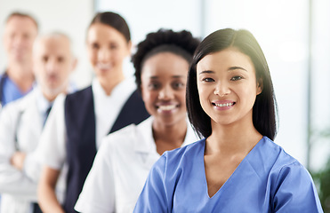 Image showing Smile, team and portrait of doctors and nurses in hospital, support and teamwork in healthcare. Health, help and medicine, confident woman doctor and group of happy medical employees in row together.