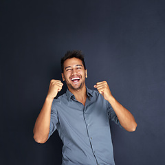 Image showing Portrait, winning and man with fist in studio for success, victory or small business loan approval. Face, hand and male entrepreneur celebrating good news or career milestone on black background