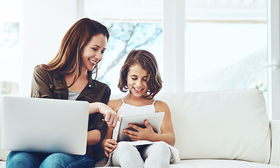 Image showing Technology, mother on laptop and helping daughter on tablet sitting on sofa in the living room of their home. Social media or connectivity, networking or streaming and woman with child happy on couch