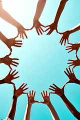 Image showing Community, support with hands in air and in blue sky outdoors for unity. Diversity or collaboration, sunlight and group of people with their hand in a circle for solidarity or trust with lens flare