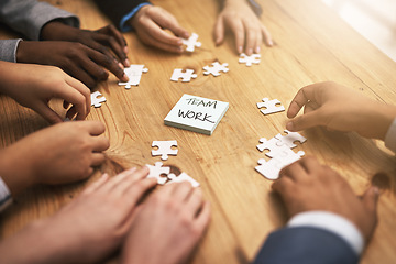 Image showing Teamwork, puzzle and hands of business meeting for brainstorming in a meeting together planning strategy at work. Circle, jigsaw and professional group of people at a table working on innovation