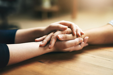 Image showing Holding hands, comfort and support of friends, care and empathy together on table in home mockup. Kindness, love and women hold hand for hope, trust or prayer, solidarity or compassion, help or unity