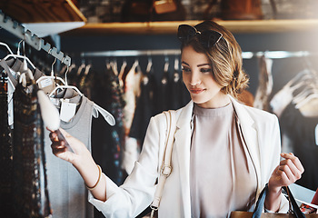 Image showing Shopping, fashion and woman with a sale, boutique and discount items with retail, client and luxury. Female person, customer and shopper with price tag, store and outfit choice with clothes selection