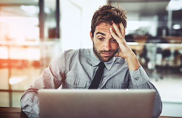 Image showing Businessman, laptop and headache in stress, burnout or overworked from strain at the office desk. Frustrated man person or employee with bad head pain or confused working on computer at the workplace