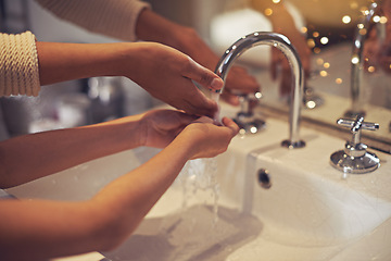 Image showing Water, closeup and washing hands by mother and child in a bathroom for learning, hygiene and care. Basin, home and hand cleaning by mom and girl together for prevention of bacteria, dirt and germs