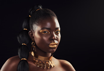 Image showing Beauty, portrait and black woman in studio with glitter, luxury and art makeup on dark background. Face, gold and African lady model with rich, glow and jewelry, elegance and cosmetic royal aesthetic