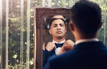 Image showing Mirror, wedding and man with a bow tie, marriage and prepare for ceremony, love and celebration. Male person, gentleman and groom with a suit, fashion and ready for event with romance and reflection