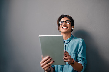 Image showing Woman, tablet and thinking with earphones by wall background with laugh, music and meme on web. Entrepreneur, earpods and mobile touchscreen with comic laughing for sound, audio and social media app