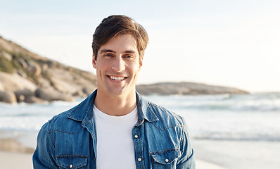 Image showing Man, portrait and beach with sunshine and smile in the outdoors for an adventure and happiness. Ocean, sun and male person is happy in the outdoor for day to relax in the summer with nature and air.