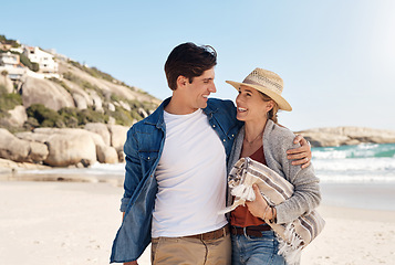 Image showing Love, happy couple at the beach and walking together hugging on seashore, Summer vacation or holiday break, adventure or traveling journey and young people walk at sea for fresh air with blue sky