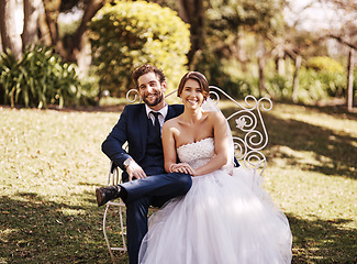 Image showing Portrait, wedding and couple sitting, outdoor and love with marriage, commitment and loving together. Face, bride and groom on a chair, loyalty and married with happiness, bonding and relationship