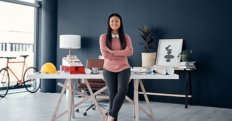 Image showing Asian, woman and portrait of architect with arms crossed in office with engineering, plan and blueprint. Face, female worker in professional architecture company workplace with confidence and smile