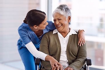 Image showing Healthcare, disability and a nurse hugging an old woman in a wheelchair during a nursing home visit. Medical, hug and funny with a laughing female medicine professional talking to a senior resident