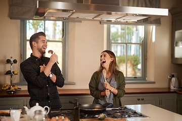 Image showing Food, sing and a silly couple in the kitchen of their home, having fun together while cooking. Karaoke, comic or funny with a man and woman laughing while singing over breakfast in their house