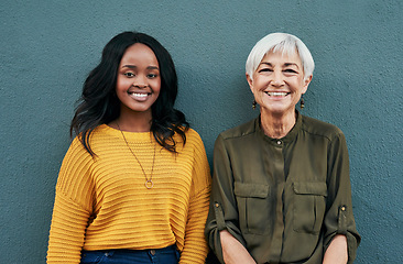 Image showing Happy, diversity and portrait of women on a blue background for success, happiness and work. Smile, business and a young and senior employee standing on a wall for a professional career break