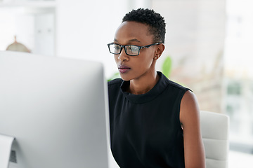 Image showing Business, computer and serious black woman in office for research, planning or concentration. Focus, mindset and African female copywriter online for creative idea inspiration on blurred background