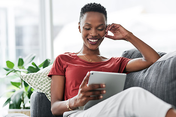 Image showing Digital tablet, happy and black woman relax on a sofa for social media, reading and browsing blog in her home. Smile, online and African female person on couch with ebook, streaming or subscription