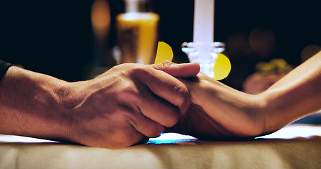 Image showing Holding hands, candle and couple on dinner date at restaurant, hotel or love on marriage anniversary celebration. Man, woman and fine dining together, trust and romance at night with hand closeup