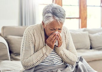 Image showing Senior woman, sick and blowing nose at home from virus, allergy and illness on couch. Tired, tissue and elderly female person in a house lounge with sneeze from covid and flu on a sofa with allergies