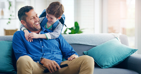 Image showing Dad, child and hug in a family home with love and care on living room sofa with a smile after school. A man or dad with a kid or son together on a couch for quality time, bonding and fathers day