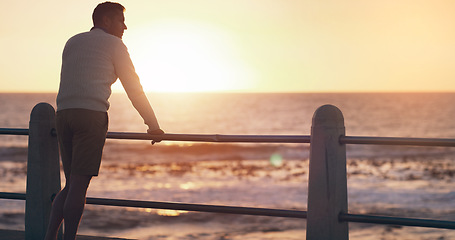 Image showing Back view, sunset and thinking man by beach on vacation or holiday mockup space. Ocean, idea and male person relax outdoor by sea for travel, freedom and enjoying summer peace alone at promenade.