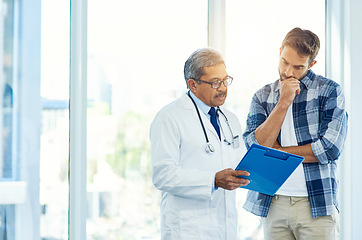 Image showing Mature doctor, man patient and results with medical consultation and discussion in clinic. Hospital, diagnose and health insurance checklist of a healthcare and wellness professional talking