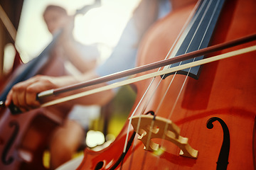 Image showing Woman, hand and cello closeup with instrument string and band outdoor playing classical music. Backyard, summer and person with talent and creativity with instruments and acoustic players together