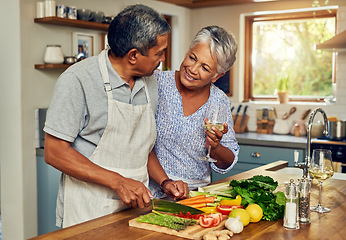 Image showing Old couple in kitchen, wine and happiness, cooking healthy food together in home with vegetables. Drink, smile and senior woman with glass in house with man, meal prep and happy lunch in retirement.