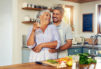 Image showing Love, hug old couple in kitchen with wine, happiness and cooking healthy vegetable dinner together. Smile, embrace and food, senior man and happy woman in retirement with drink, vegetables and health