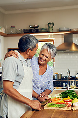 Image showing Love, vegetables and old man with happy woman at kitchen counter, embrace and healthy marriage bonding in home. Happiness, help and cooking, senior couple with smile, hug and dinner in retirement.