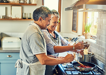 Image showing Help, cooking together and old couple in kitchen with smile, health and frying healthy food at stove. Love, senior man helping happy woman prepare lunch and meal in pan, retirement and dinner in home