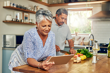 Image showing Senior woman at kitchen counter with man, tablet and cooking healthy food together in home. Digital recipe, smile and old couple in house with meal prep, happiness and wellness diet in retirement.
